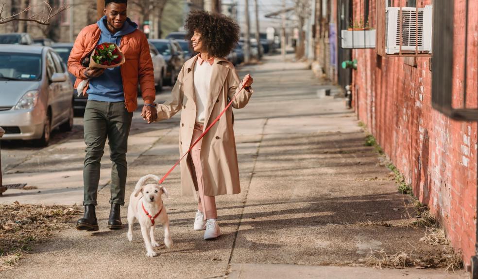 A couple walking their dog A couple walking their dog