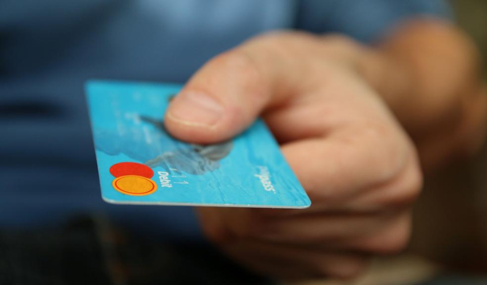 Person Holding Debit Card Person Holding Debit Card