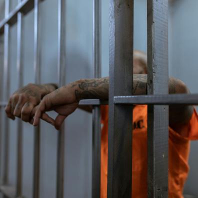 A Person in Orange Shirt with Tattooed Arms