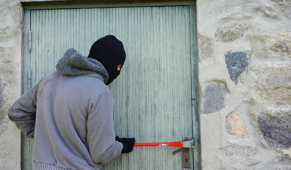 A burglar breaking into a house A burglar breaking into a house